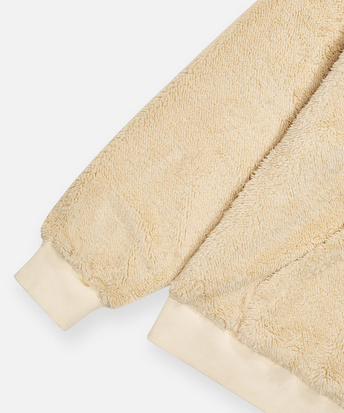 Paper Plane ecru sherpa half-zip pullover with faux sherpa letter appliqué, kangaroo pocket, and relaxed fit.