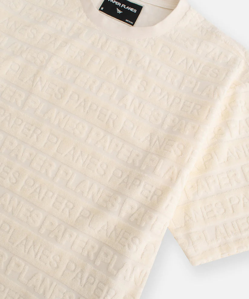 beachfront terry cloth oversized tee with allover paper planes wordmark and rib collar laid flat