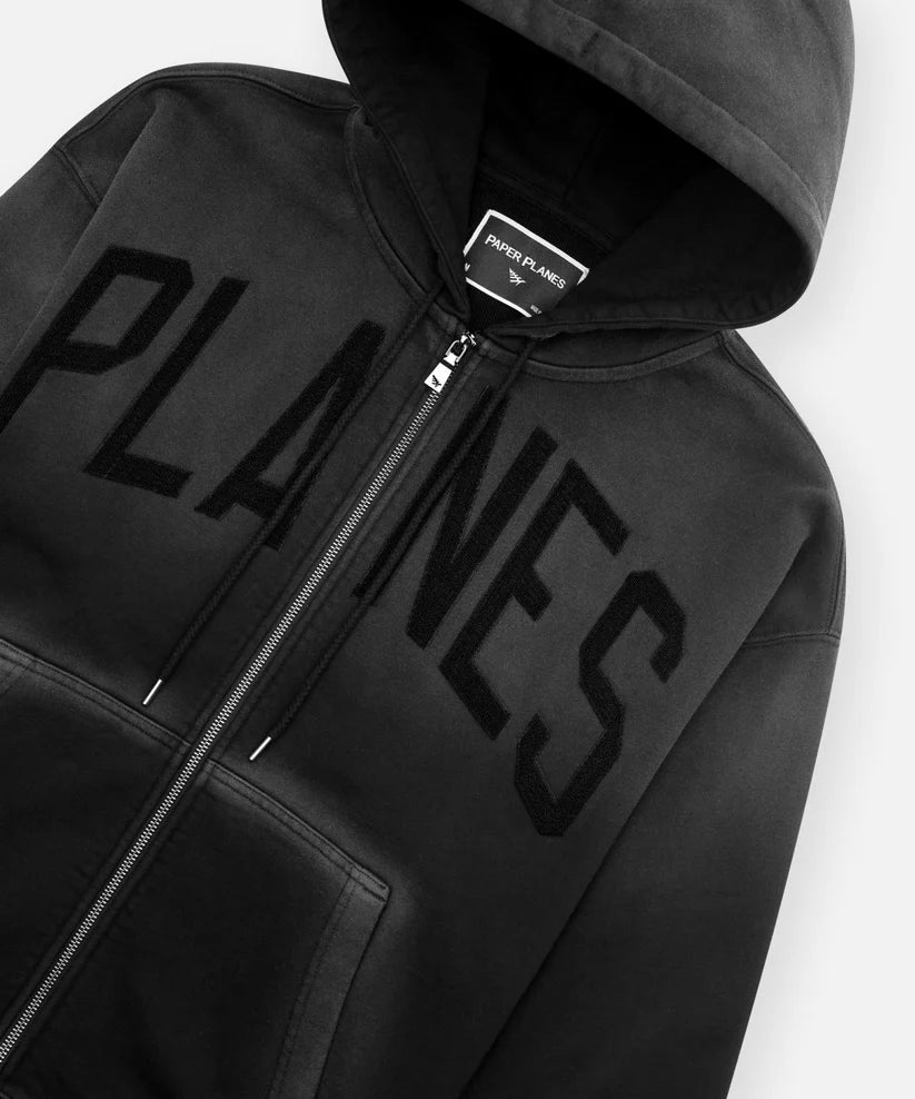 Black Paper Planes Planes Arched Heavyweight Zip Hoodie with towel embroidery, pigment spray effect, silicone flag, and relaxed fit.