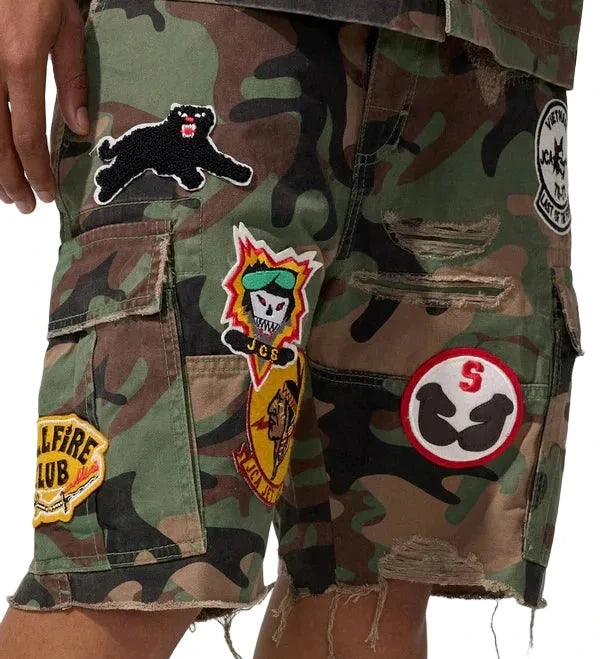Jordan Craig Retro War Angel cargo shorts with camo print, stitched patches, and raw edge detailing in relaxed streetwear fit