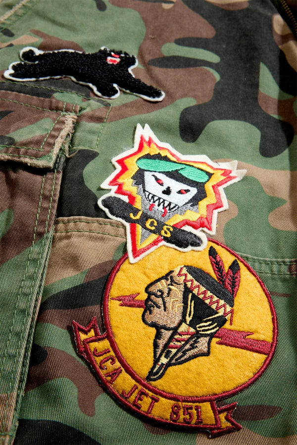 Jordan Craig Retro War Angel cargo shorts with camo print, stitched patches, and raw edge detailing in relaxed streetwear fit