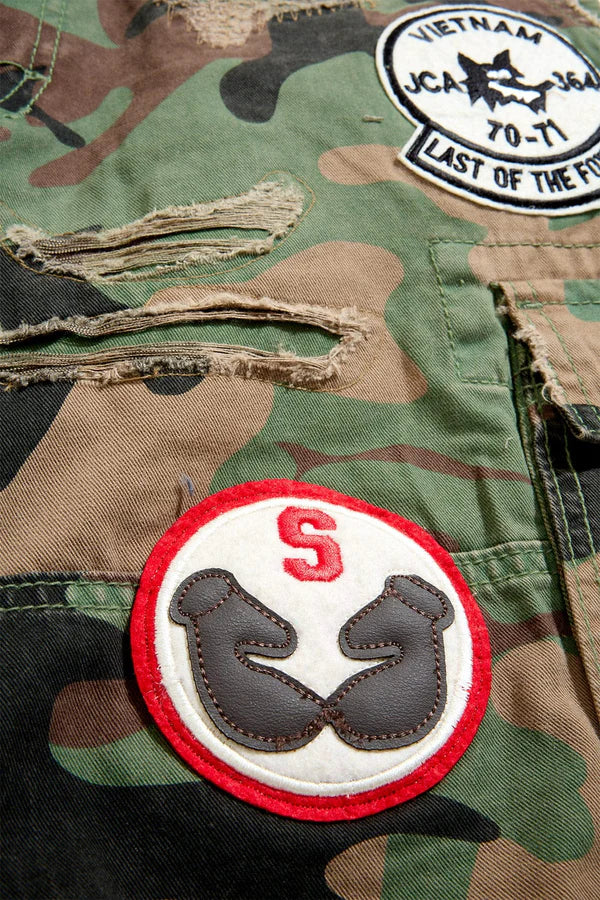Jordan Craig Retro War Angel cargo shorts with camo print, stitched patches, and raw edge detailing in relaxed streetwear fit