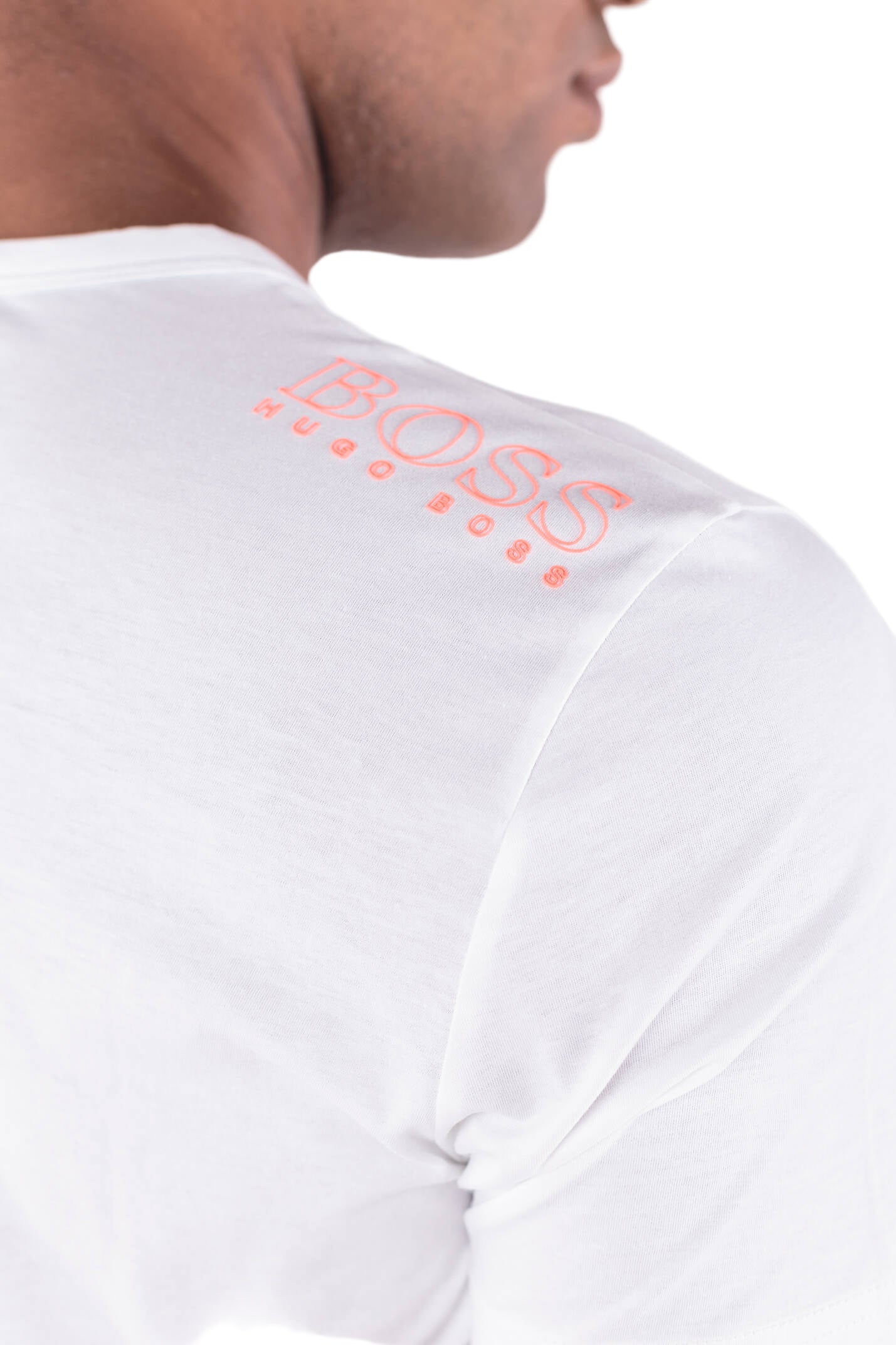 Elevate your everyday essentials with the Hugo Boss Basic Tee (White) featuring a bold orange front logo and matching back-neck branding. 