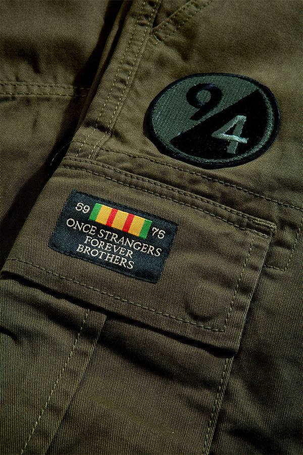 Xavier Prestige Tonal Cargo Pants in cotton with loose hip-to-thigh fit, tapered legs, functional cargo pockets, and tonal embroidered patches