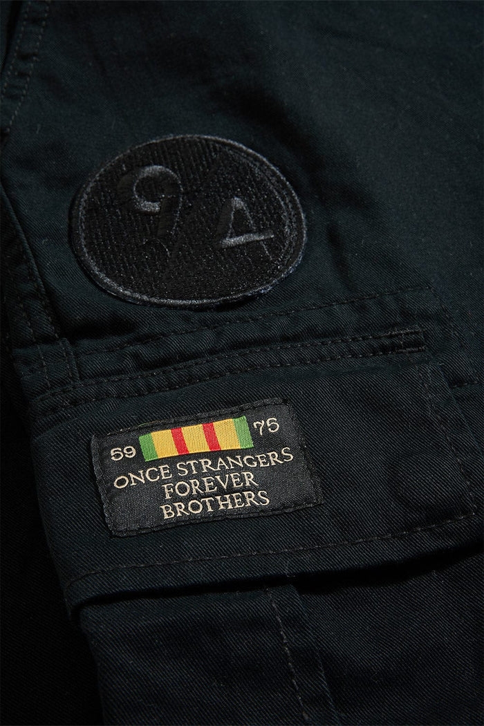 Xavier Prestige Tonal Cargo Pants in cotton with loose hip-to-thigh fit, tapered legs, functional cargo pockets, and tonal embroidered patches
