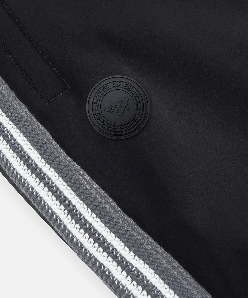 Paper Plane black Planes Crochet track pants with crochet side panels and water-resistant nylon fabric.