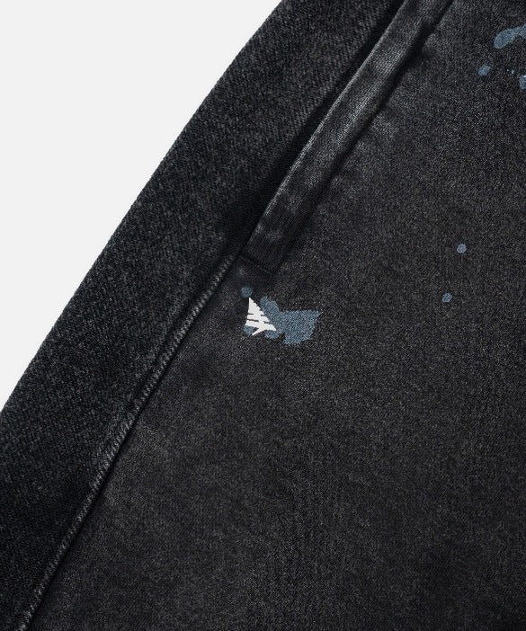 Paper Plane black heavyweight sweatpants with splatter effect, zippered pockets, and elastic waistband.