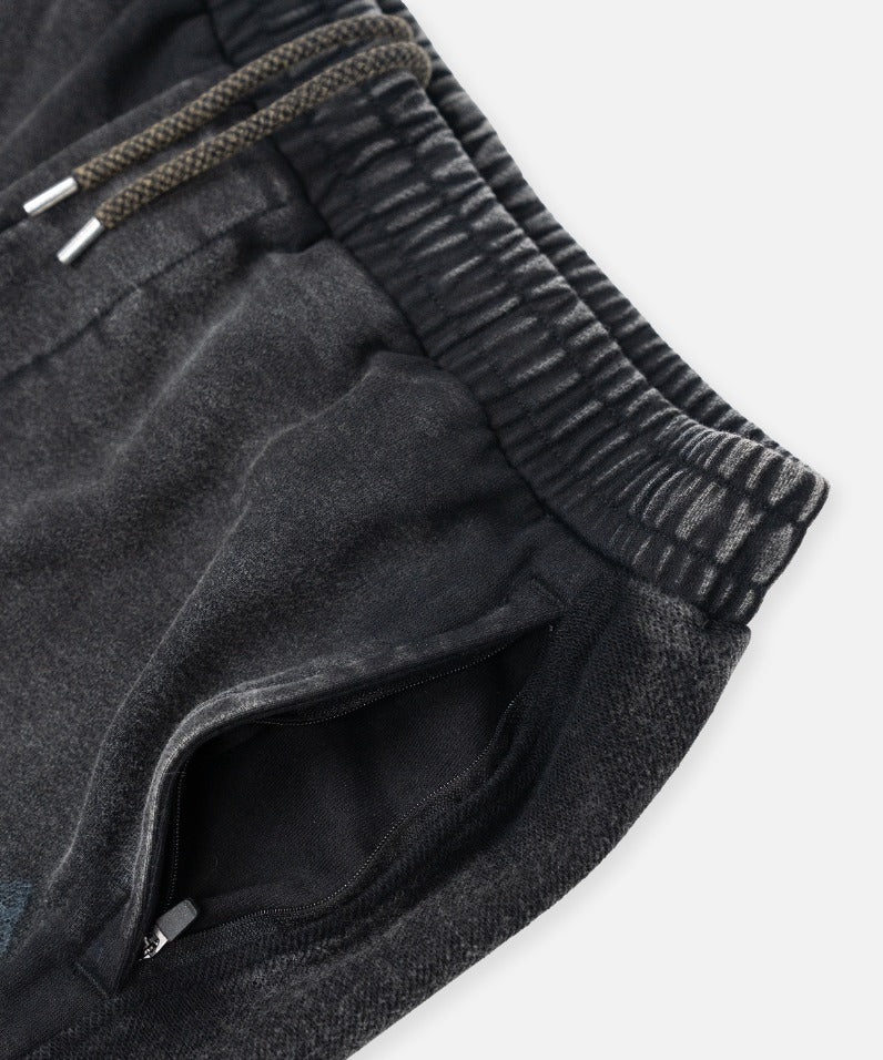 Paper Plane black heavyweight sweatpants with splatter effect, zippered pockets, and elastic waistband.