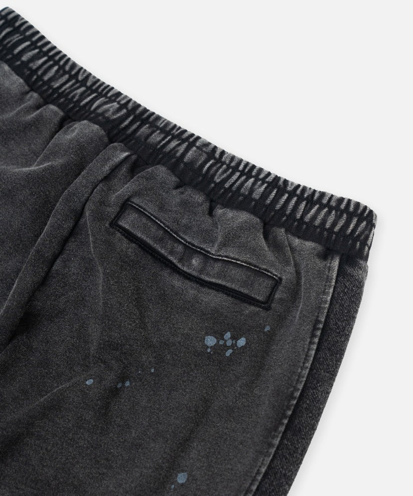 Paper Plane black heavyweight sweatpants with splatter effect, zippered pockets, and elastic waistband.