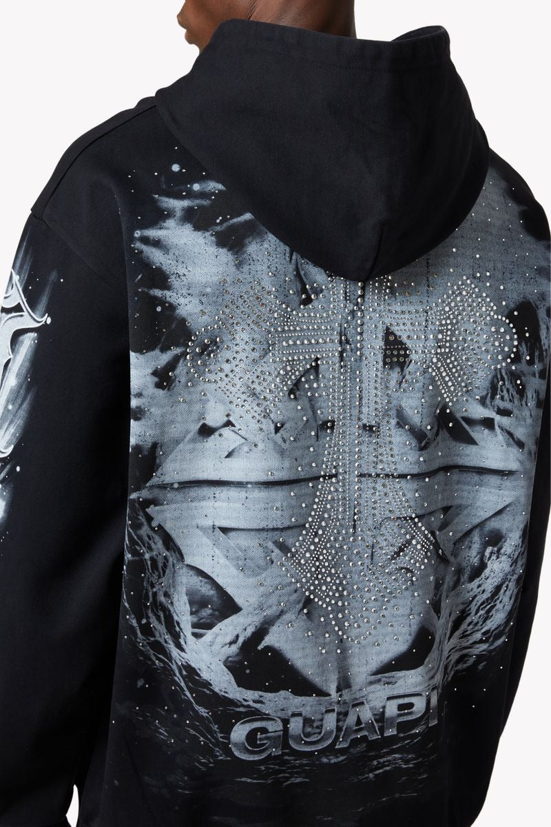 GUAPI Heavens Vault Hoodie V3 in jet black with ice blue and white graphics, crystal rhinestone embellishments, double-eagle front print, cosmic back emblem, and oversized drop-shoulder fit.