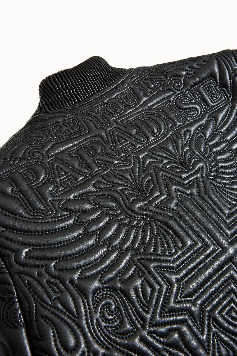 “Sinister Bomber Jacket – Charcoal: classic bomber silhouette, quilted embroidery, vegan leather accents, insulated channels, and branded zippers for style and warmth.”