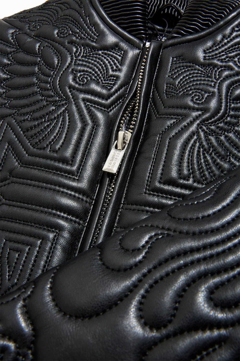 “Sinister Bomber Jacket – Charcoal: classic bomber silhouette, quilted embroidery, vegan leather accents, insulated channels, and branded zippers for style and warmth.”