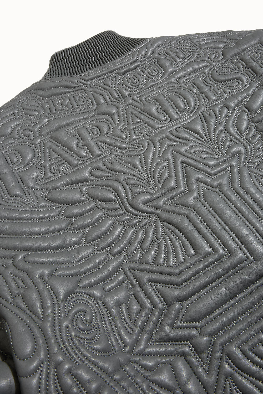 “Sinister Bomber Jacket – Charcoal: classic bomber silhouette, quilted embroidery, vegan leather accents, insulated channels, and branded zippers for style and warmth.”