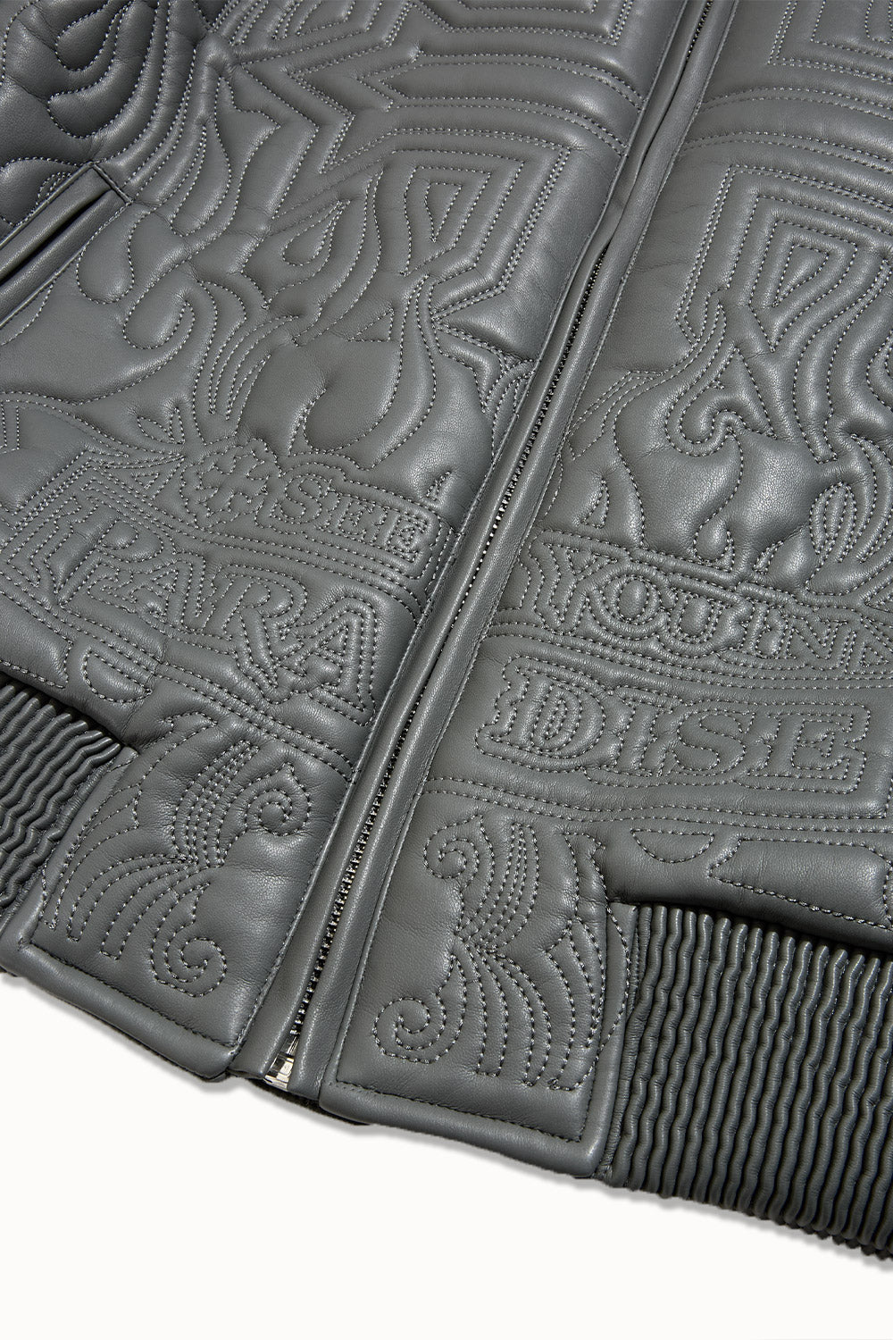 “Sinister Bomber Jacket – Charcoal: classic bomber silhouette, quilted embroidery, vegan leather accents, insulated channels, and branded zippers for style and warmth.”