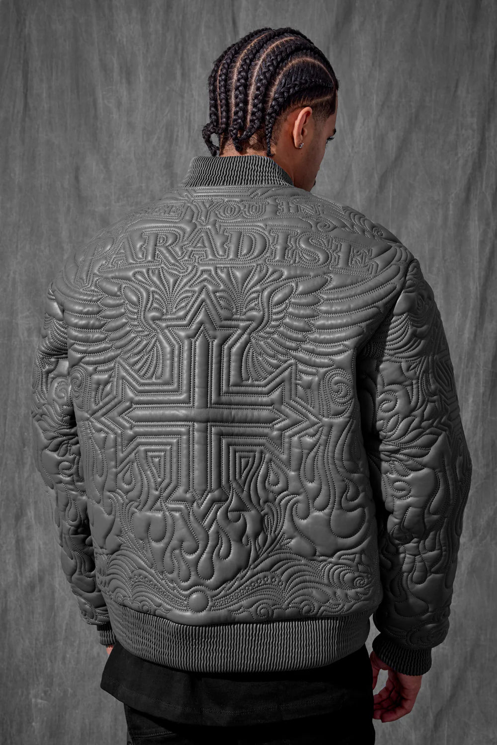 “Sinister Bomber Jacket – Charcoal: classic bomber silhouette, quilted embroidery, vegan leather accents, insulated channels, and branded zippers for style and warmth.”