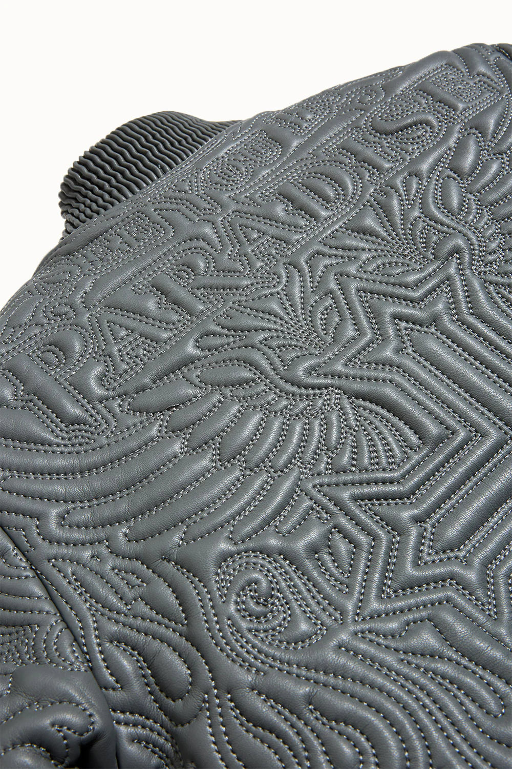 “Sinister Bomber Jacket – Charcoal: quilted embroidery, vegan leather accents, insulated channels, ribbed cuffs, and branded zippers for style and warmth.”