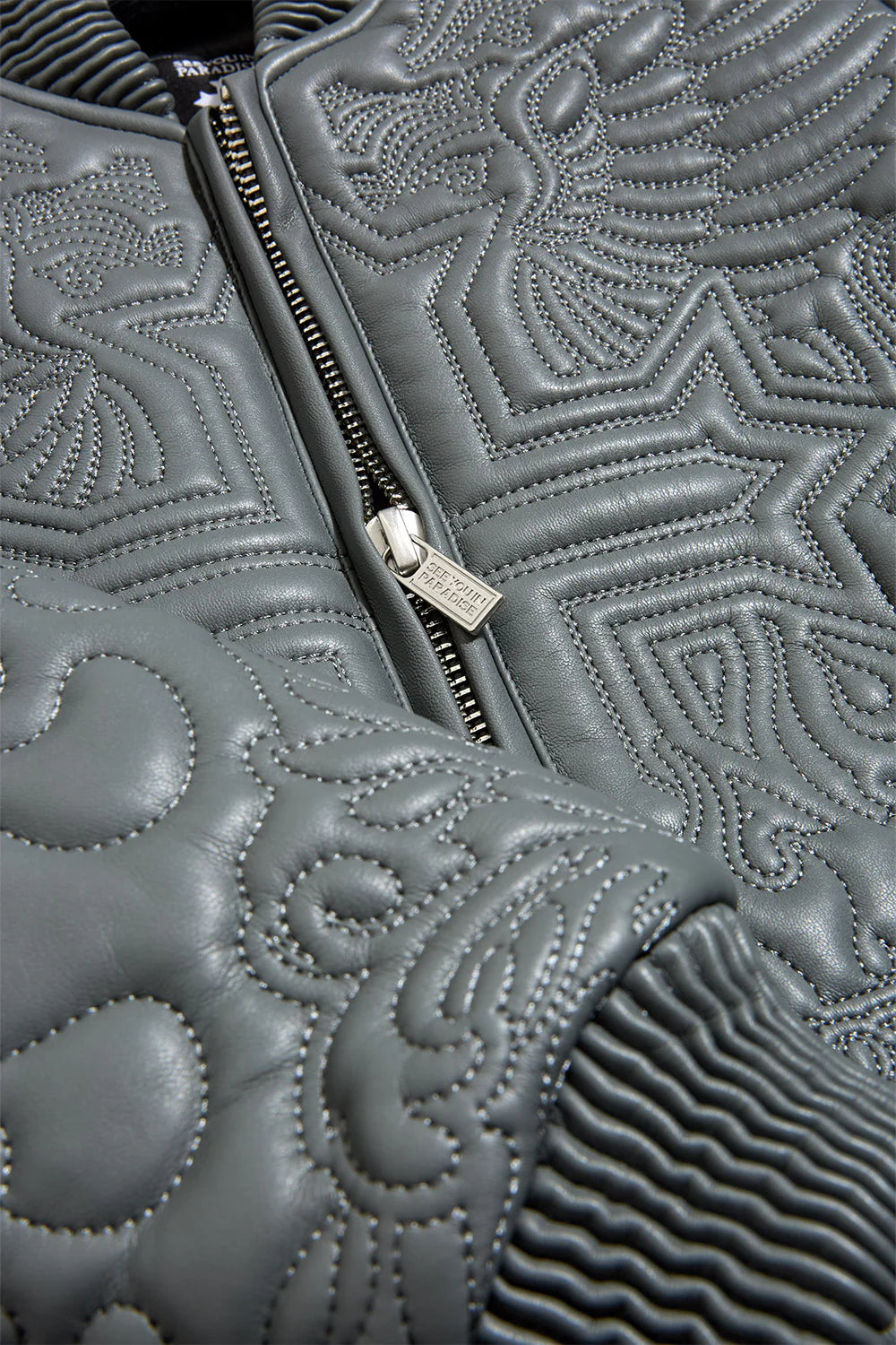 “Sinister Bomber Jacket – Charcoal: quilted embroidery, vegan leather accents, insulated channels, ribbed cuffs, and branded zippers for style and warmth.”