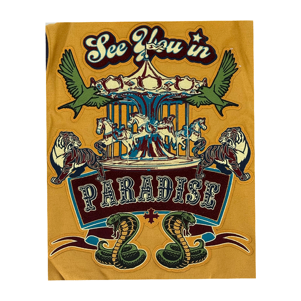 The SYIP Team Varsity Jacket for kids in Mustard delivers classic varsity style with premium detailing. Crafted with a wool body and vegan leather sleeves alongside a quilted satin lining, it offers both comfort and durability. Striped ribbed trims, chenille patches, and embroidered designs throughout give the jacket a standout, street-ready look. A snap button front closure ensures easy wear for everyday styling.