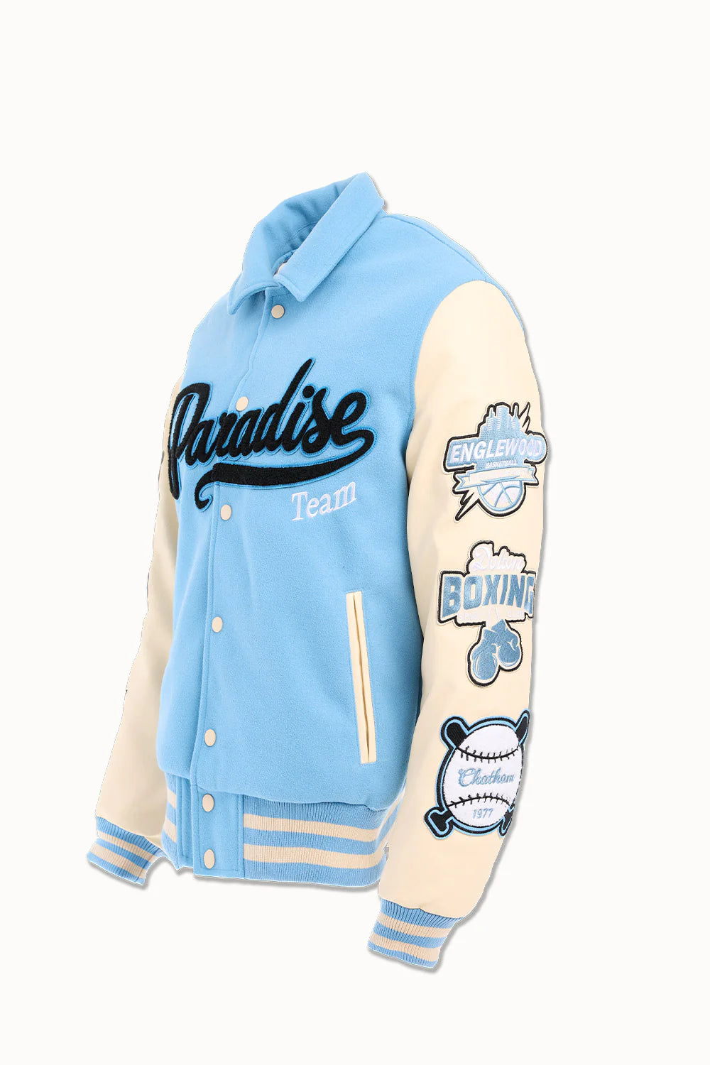 “Paradise Team Varsity Jacket – Sky Blue: wool body, quilted satin lining, vegan leather sleeves, chenille patches, embroidered details, and snap button front.”