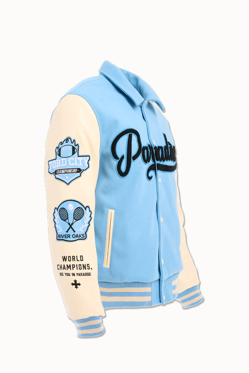 “Paradise Team Varsity Jacket – Sky Blue: wool body, quilted satin lining, vegan leather sleeves, chenille patches, embroidered details, and snap button front.”