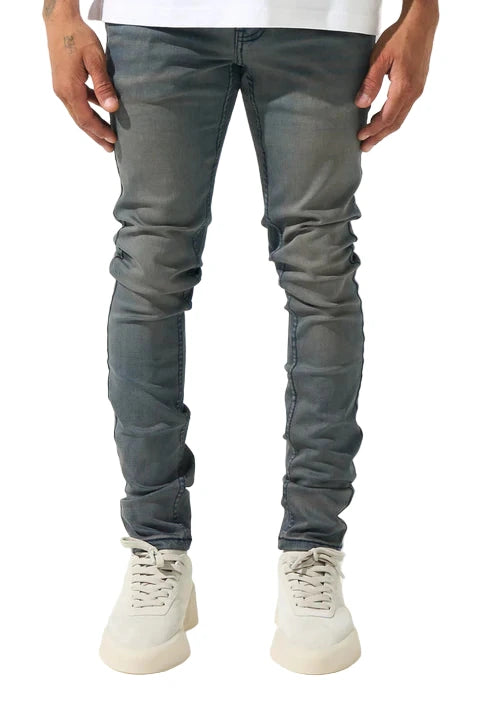 SERENEDE® ABYSS faded grey and muted blue wash jeans with fitted construction, embroidered logo, leather waistband patch, branded hardware, and five-pocket styling