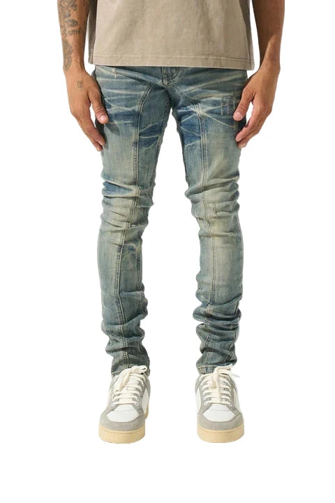 SERENEDE® ATLAS vintage sea blue-concrete jeans with fitted construction, distressing on top thigh, whiskering fade, leather waistband patch, holographic hangtag, and branded hardware