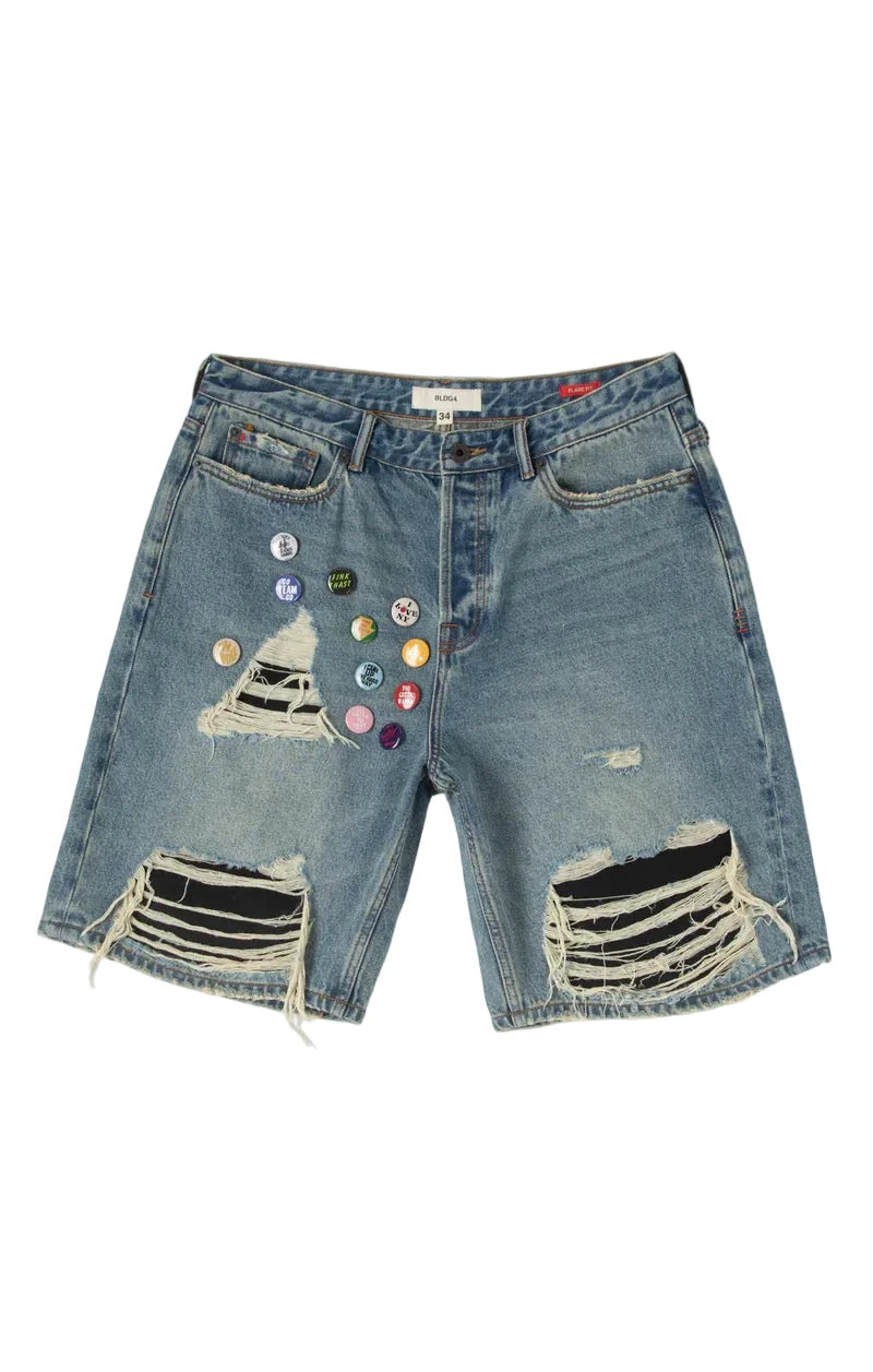 Distressed denim shorts with colorful buttons on a white background