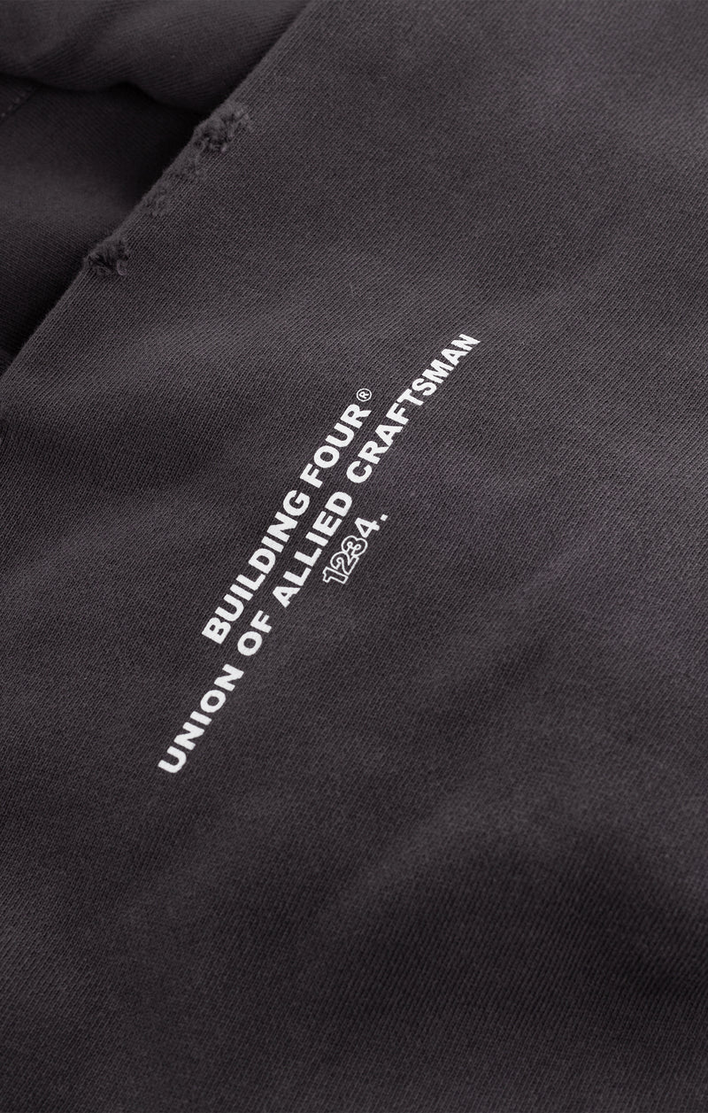 Le Chateau Hoodie in washed Charcoal Art with large peace-sign graphic, studded leather and pin detailing, full metal zip, and boxy French terry silhouette