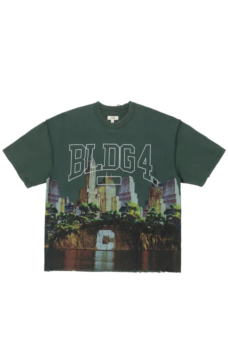 BLDG4 Big C Knit graphic T-shirt with a snow-washed finish, full-width cityscape graphic, oversized BLDG4 lettering, pin cluster at the chest, and reverse seam construction.