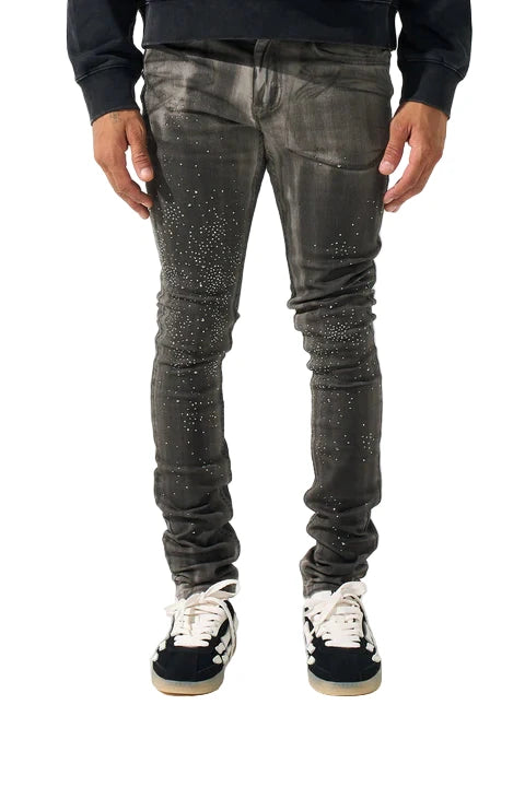 SERENEDE® COSMOS light grey jeans with black overspray, multi-sized gems, fitted construction, leather waistband patch, holographic hangtag, and branded hardware