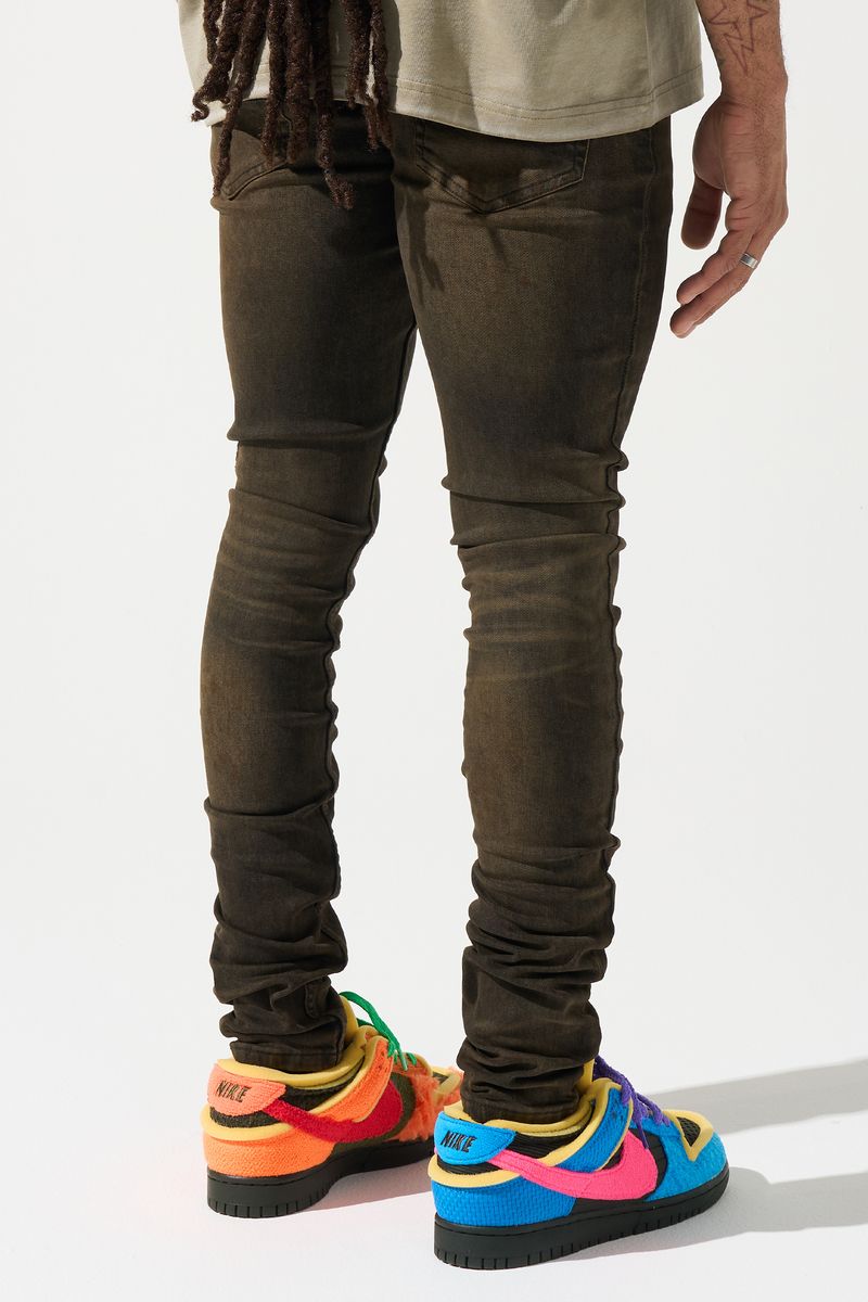 SERENEDE® Cortado fitted jeans in espresso brown denim with subtle fading, elongated inseam, and branded detailing.