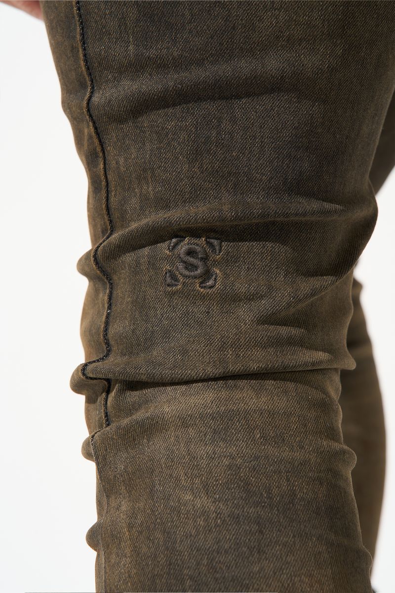 SERENEDE® Cortado fitted jeans in espresso brown denim with subtle fading, elongated inseam, and branded detailing.