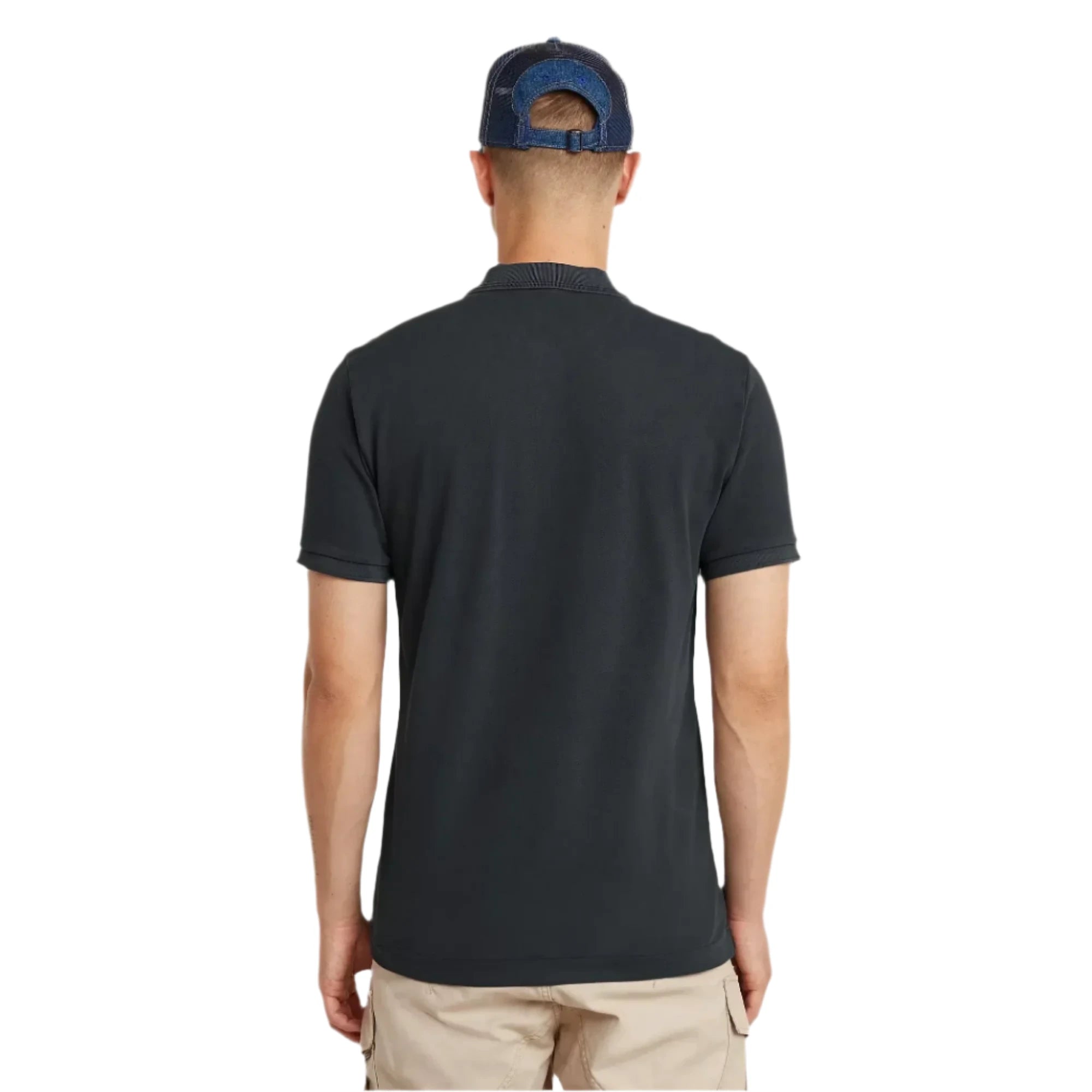 Man wearing a black polo shirt and blue cap from behind on a light gray background