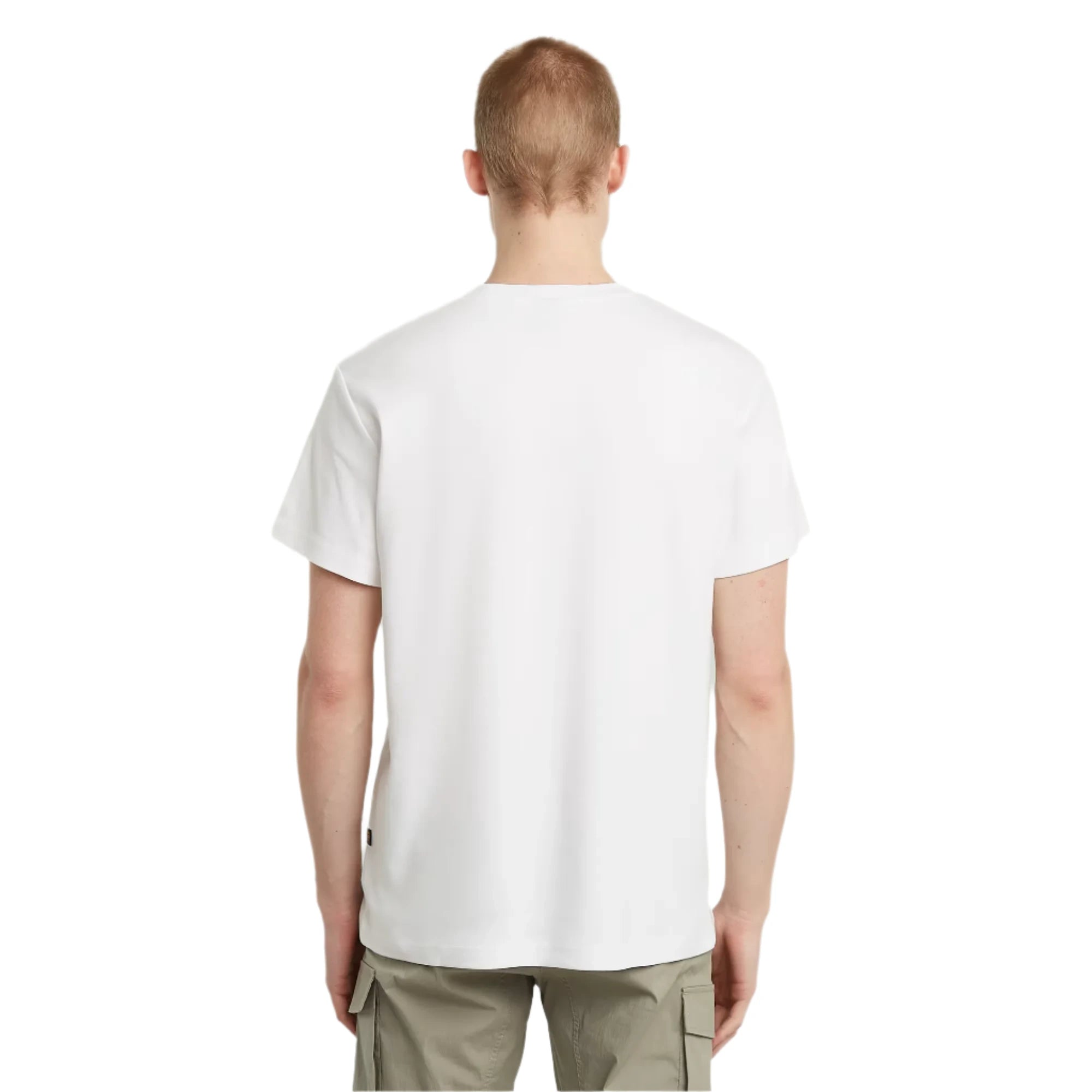 Person wearing a plain white t-shirt on a light gray background