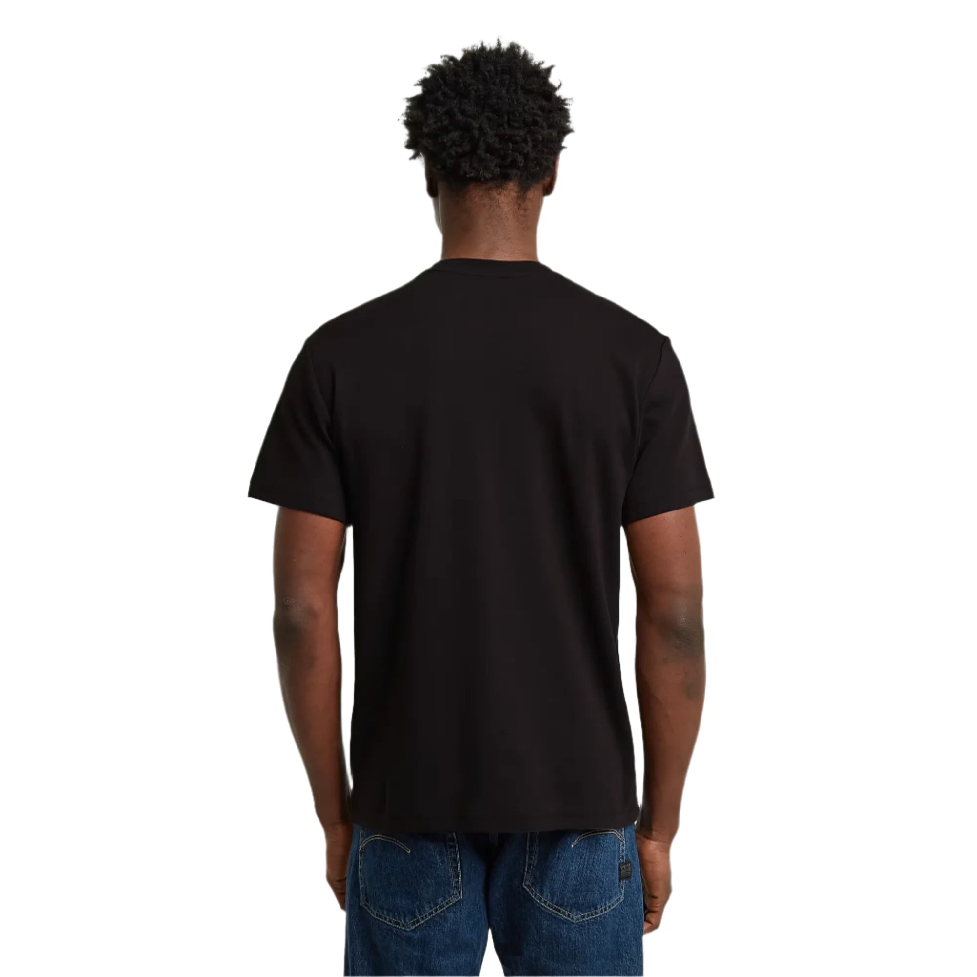 Person wearing a black t-shirt and blue jeans on a light gray background