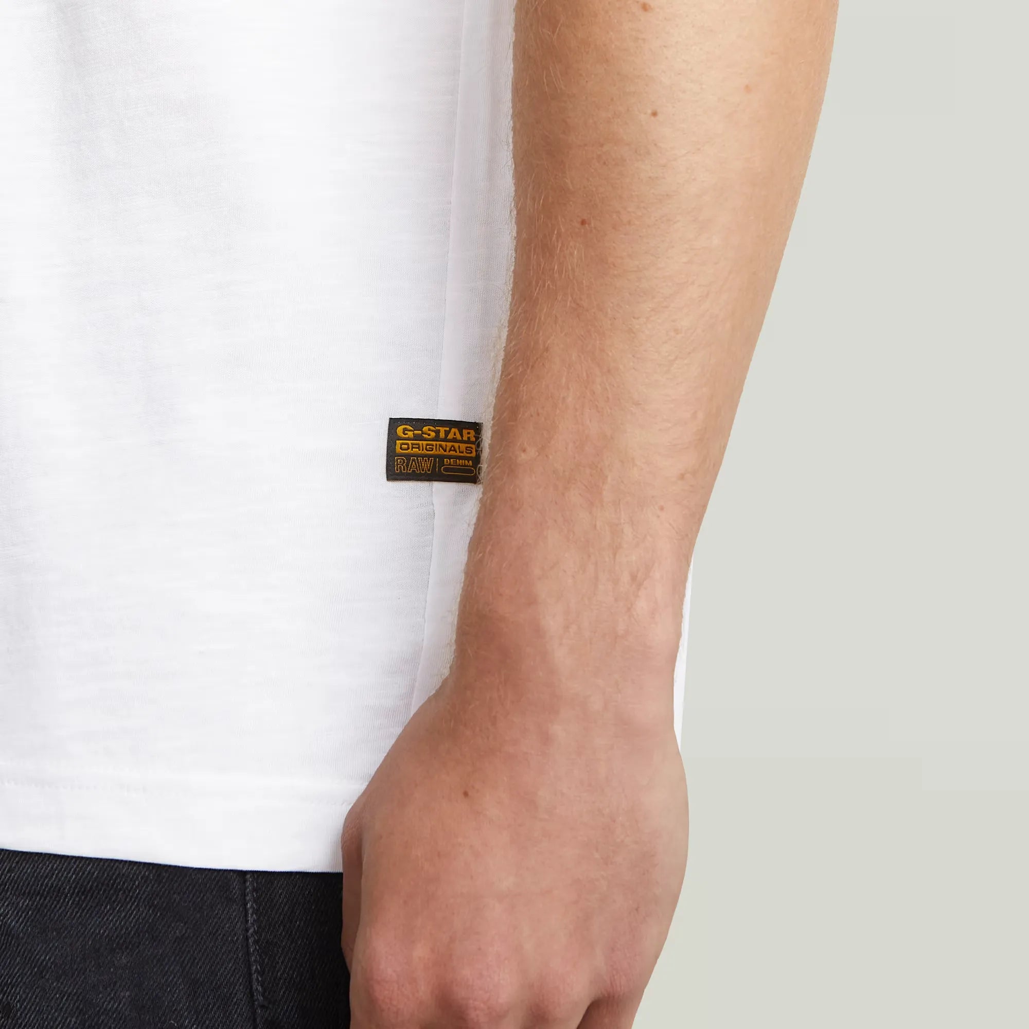 Purveyors T-shirt in white with a round neck and graphic print on the front.