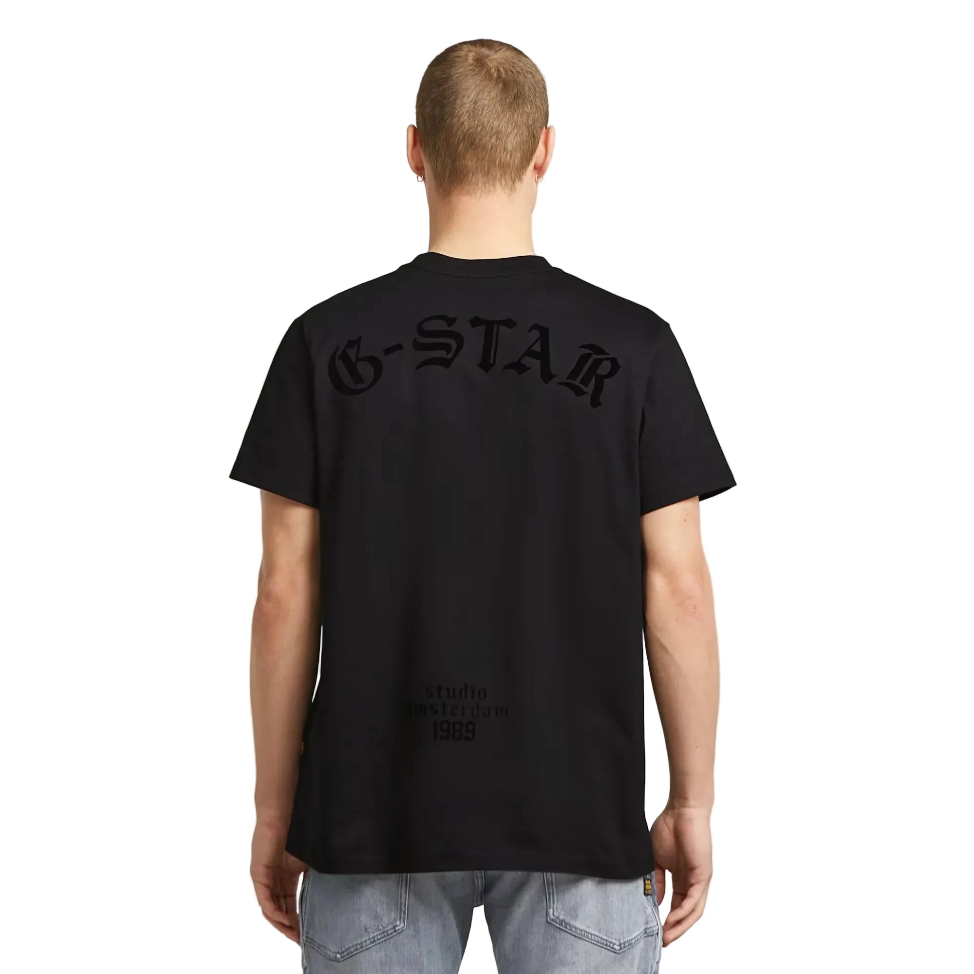 Flock Back Loose T-shirt in dark black with a bold graphic design on the back.