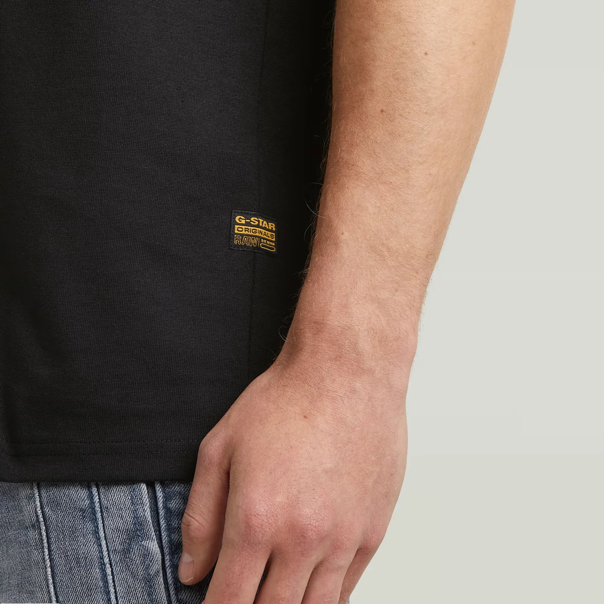 Flock Back Loose T-shirt in dark black with a bold graphic design on the back.