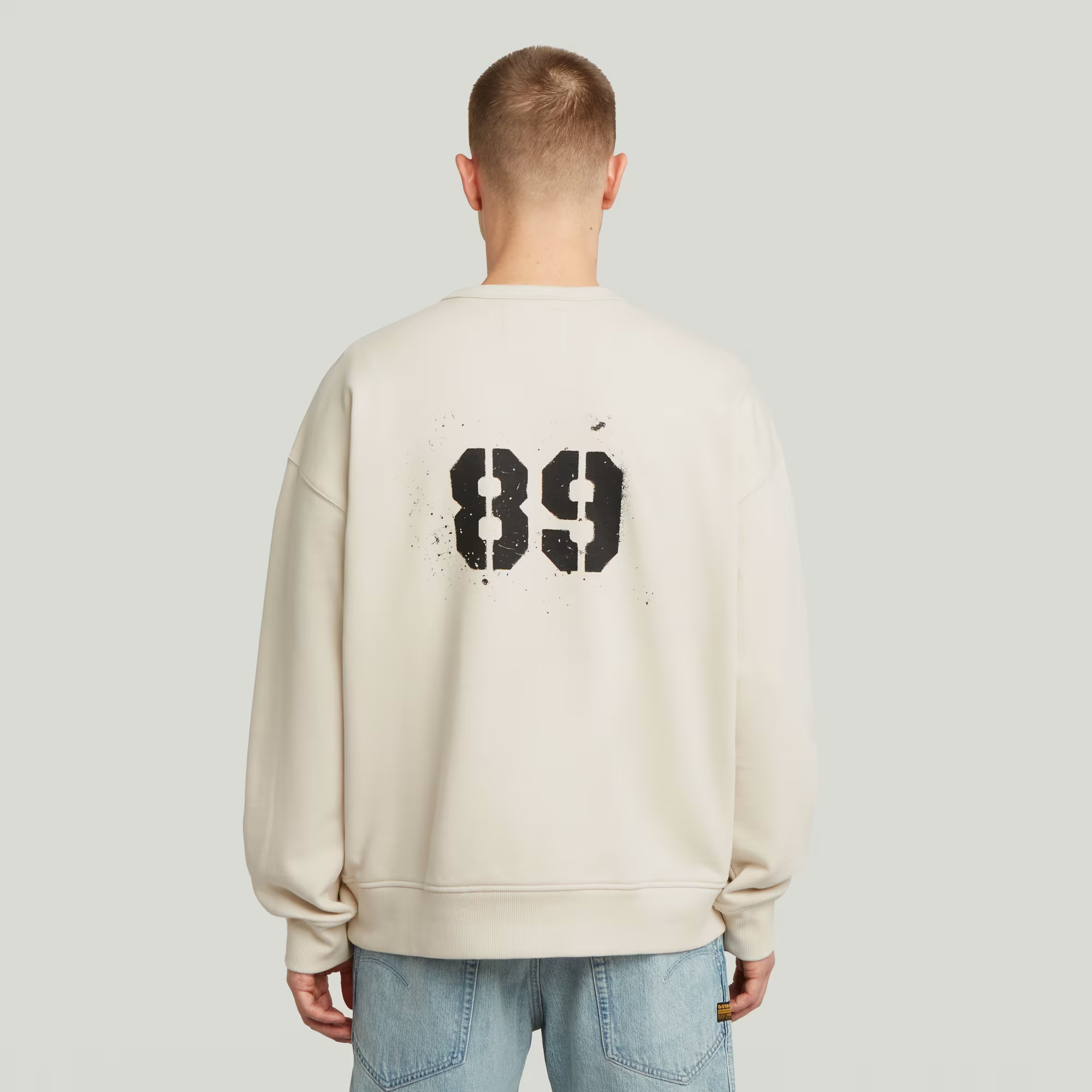 Sprayed 89 Graphic Loose Sweater in White Bait with round neck, long sleeves, and graphic print