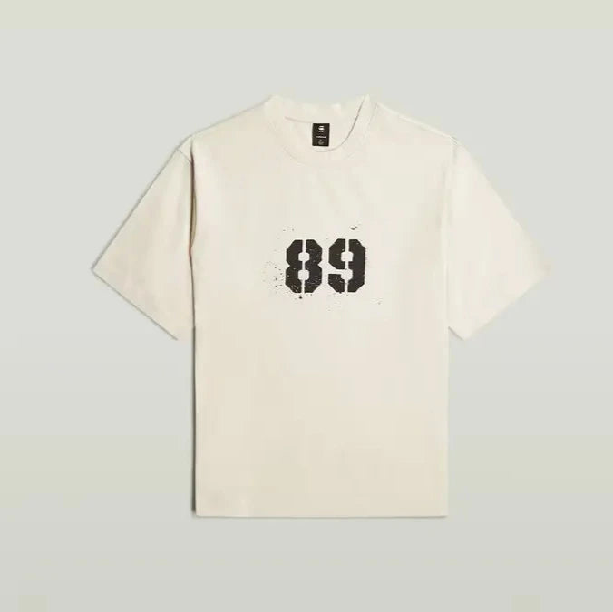 Beige t-shirt with black number '89' on a light gray background
