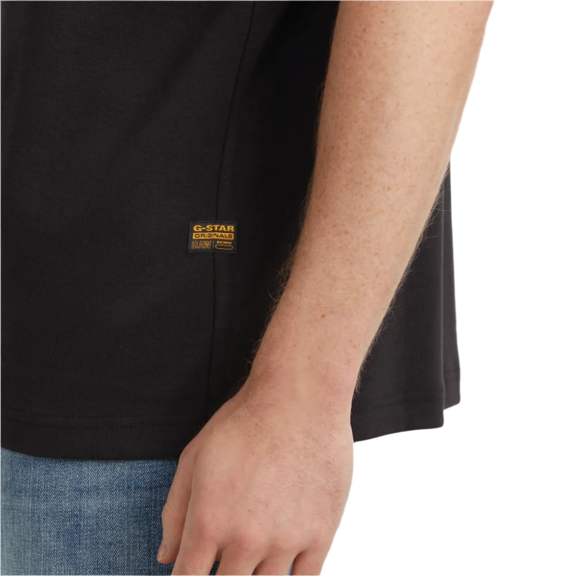 Close-up of a person wearing a black G-Star Raw t-shirt with a visible brand logo.