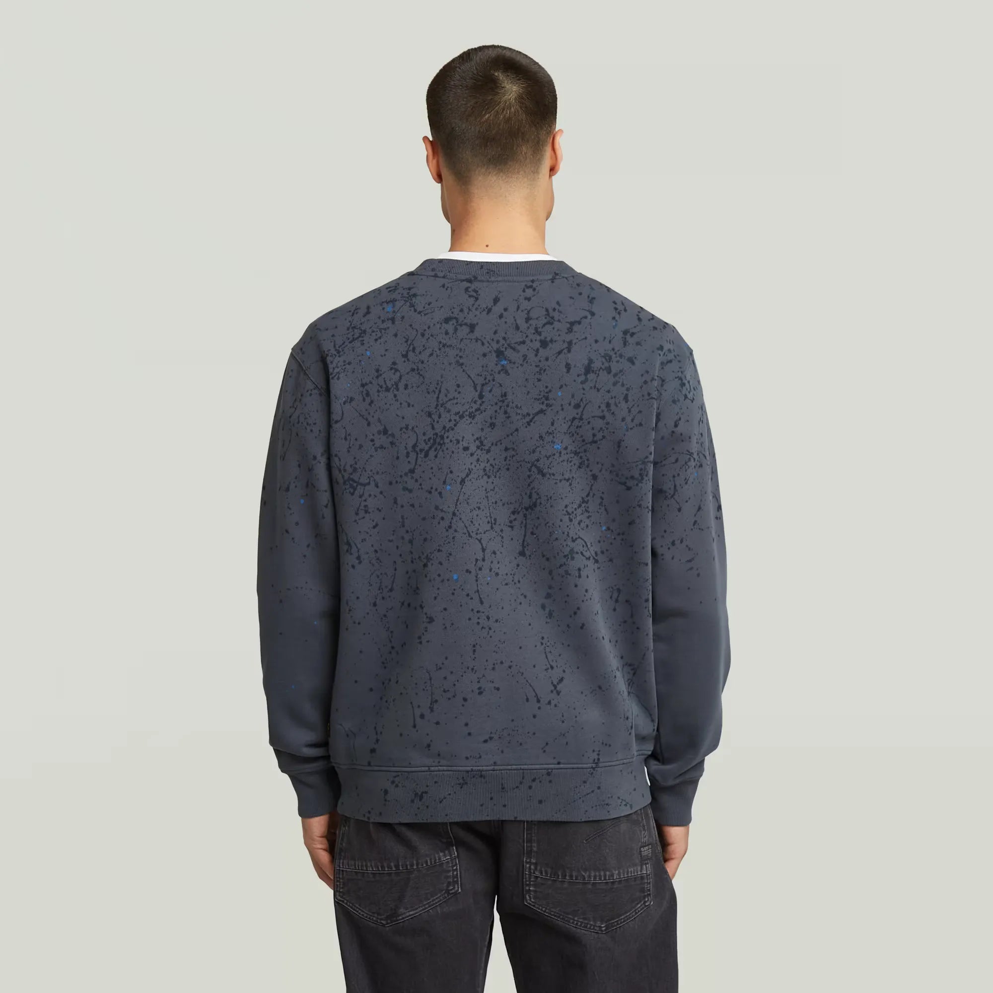 Paint Splatter Relaxed Sweater in India Ink with artistic paint splatter design.