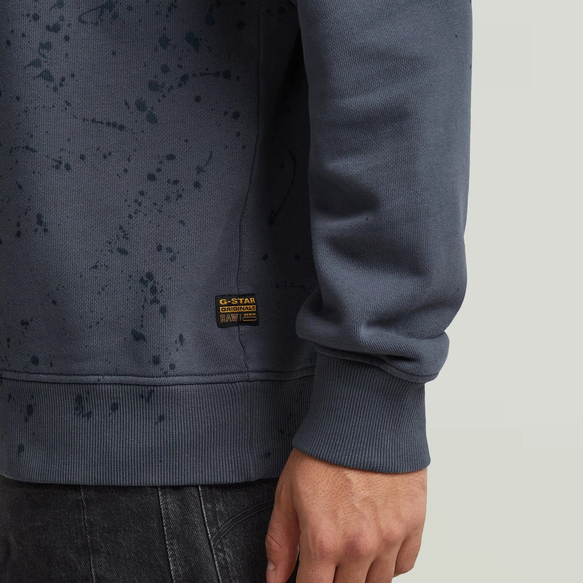 Paint Splatter Relaxed Sweater in India Ink with artistic paint splatter design.