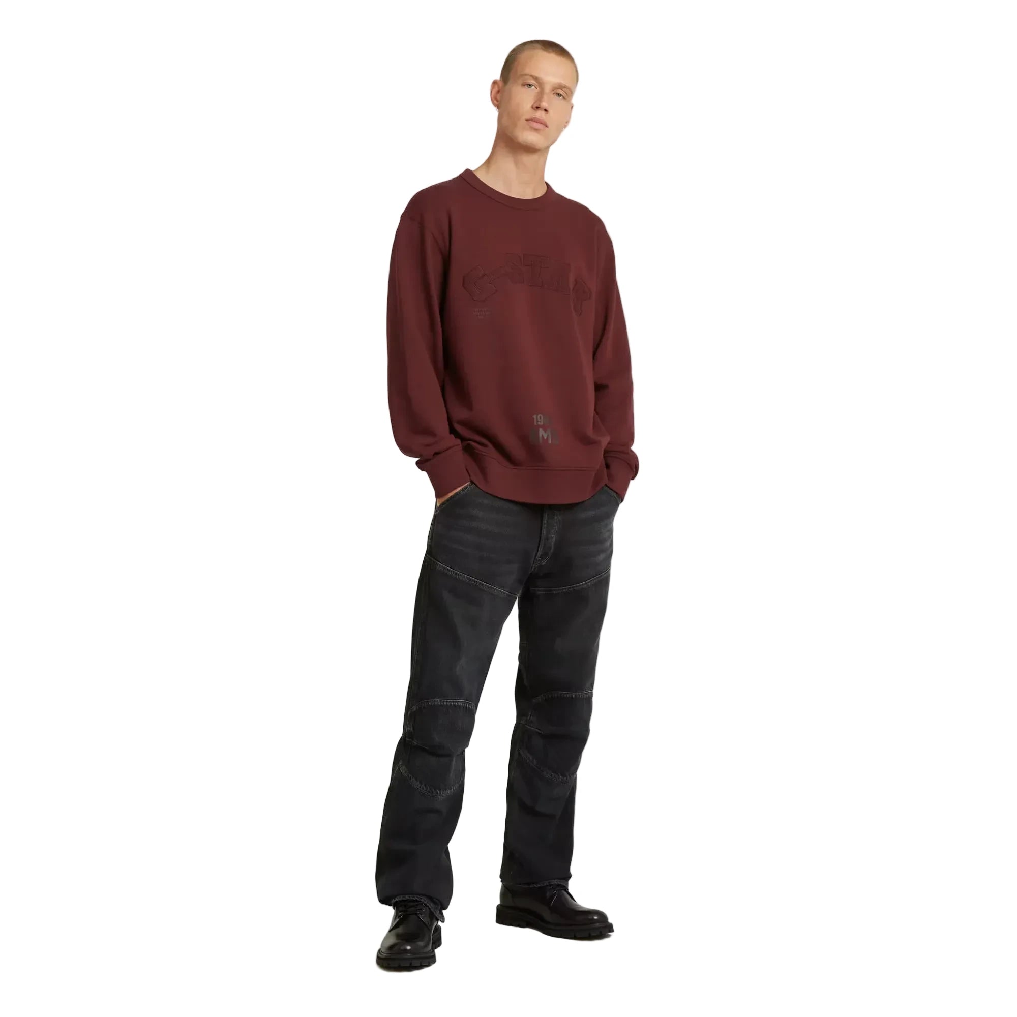 Applique sweater in port red with a round neck and graphic design.