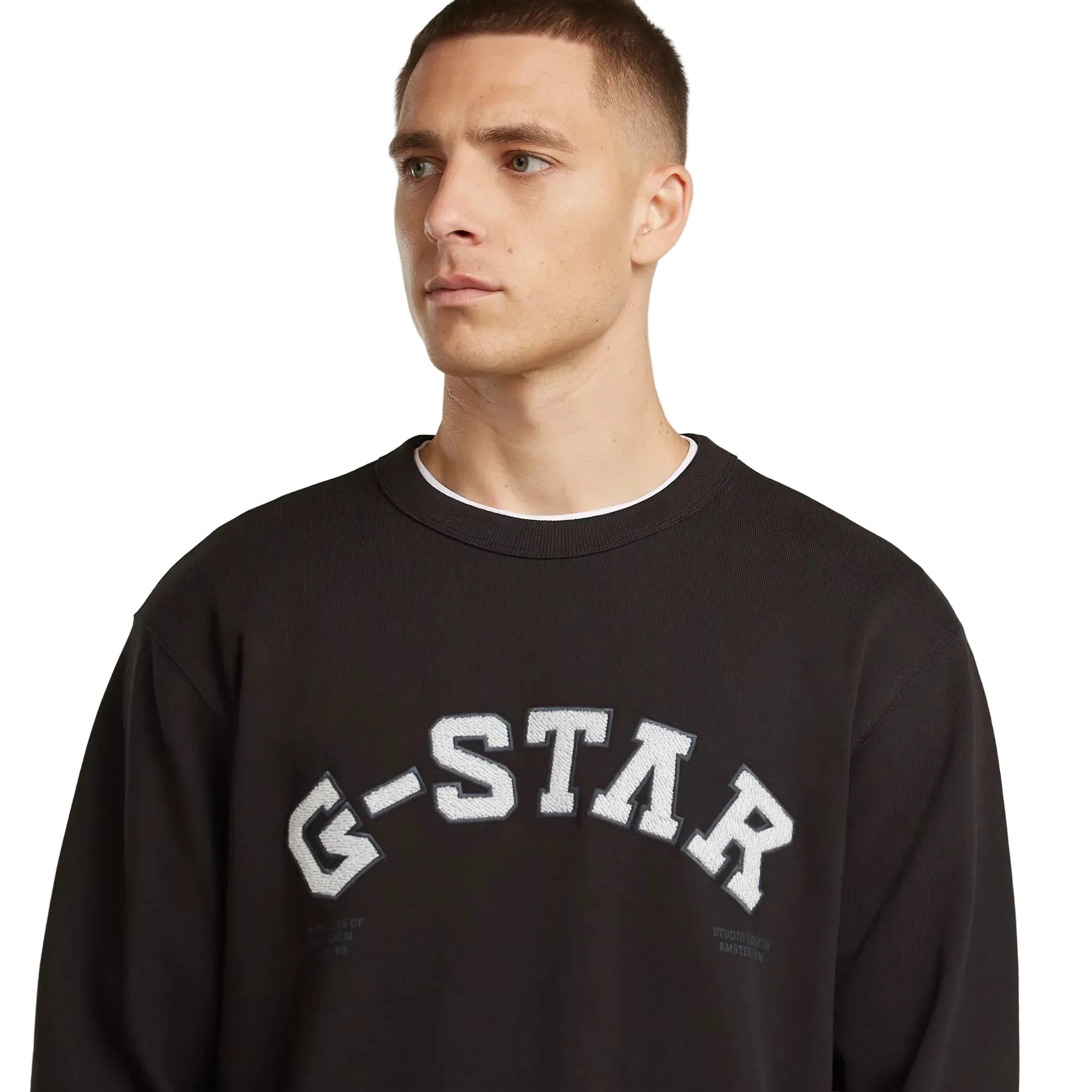 Applique sweater in dark black with a chest applique graphic and ribbed cuffs and hem.