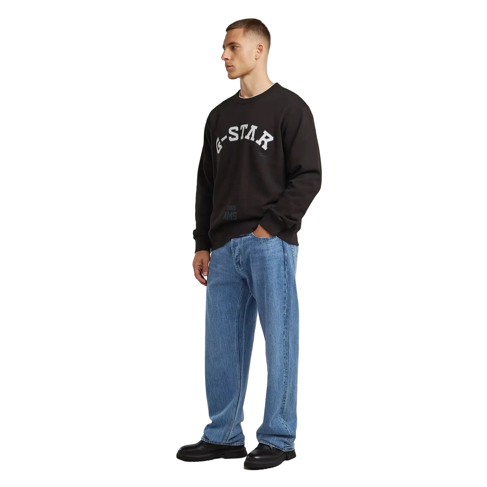 Applique sweater in dark black with a chest applique graphic and ribbed cuffs and hem.