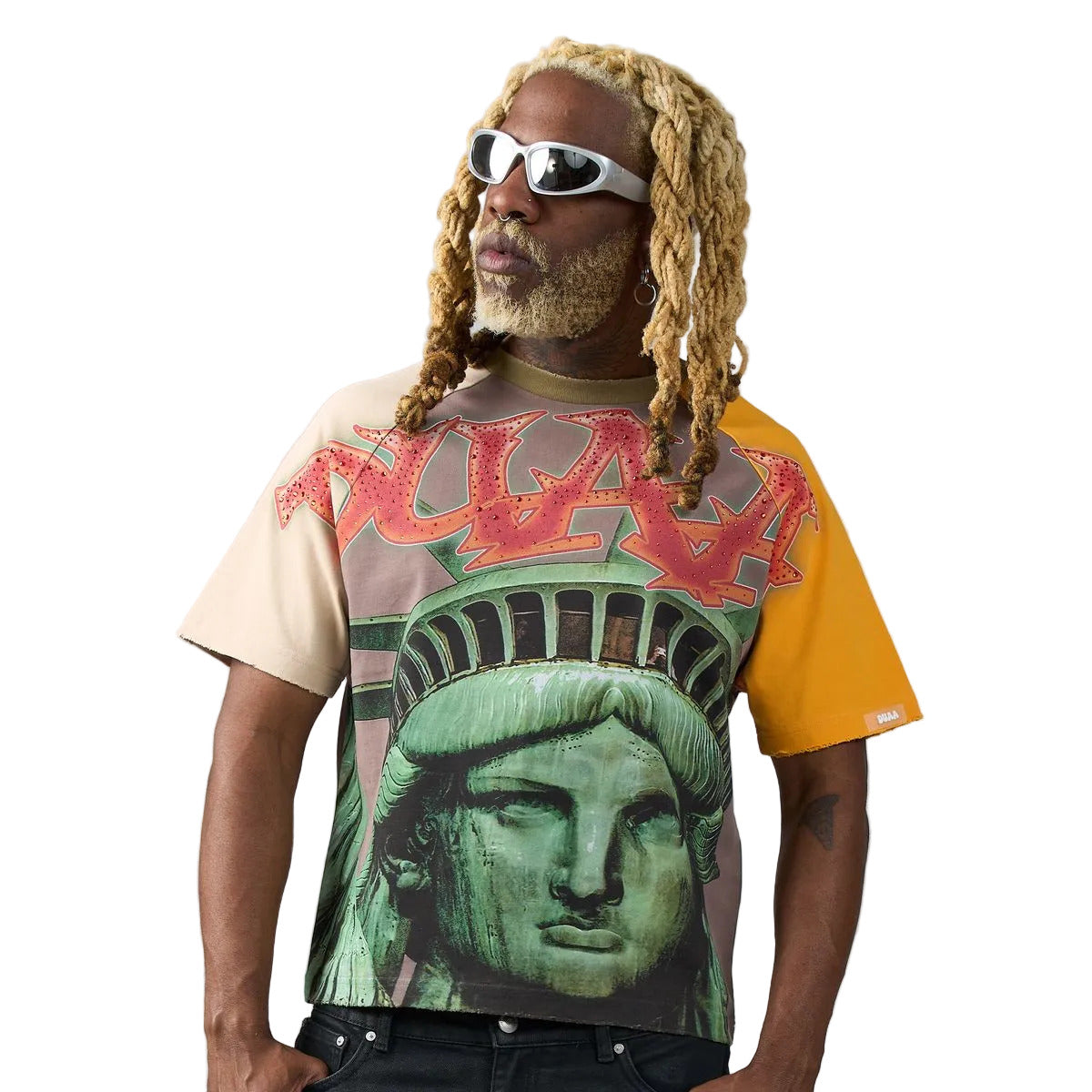 Tan raglan T-shirt with yellow and mauve sleeves, Statue of Liberty front graphic, rhinestone DUAA flame lettering, and DUAA graffiti back print.