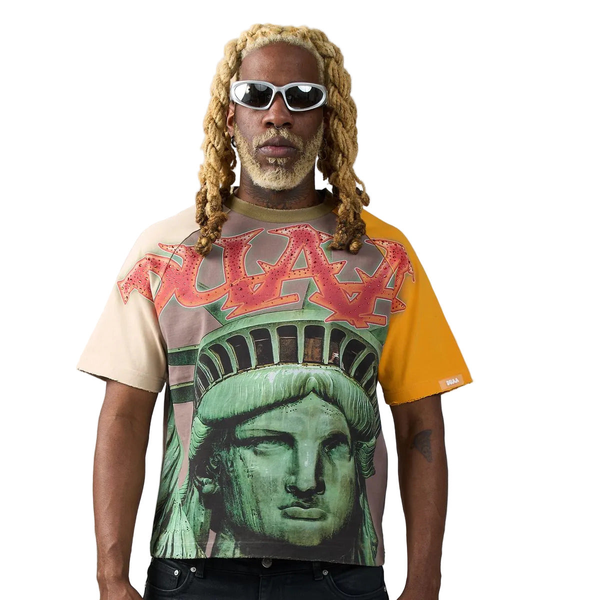 Tan raglan T-shirt with yellow and mauve sleeves, Statue of Liberty front graphic, rhinestone DUAA flame lettering, and DUAA graffiti back print.
