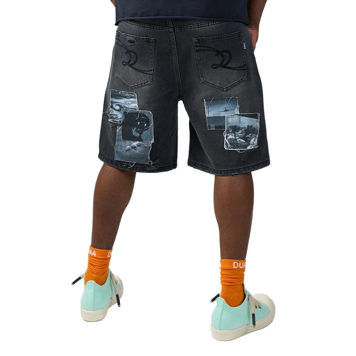 DUAA Movie Blue denim shorts in a black wash with collage photo print patches, DUAA script and number 28 graphics, embroidered back pockets, and a drawstring waist.