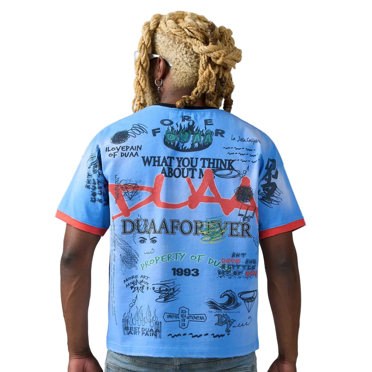 Person wearing a blue t-shirt with text and graphics on the back, standing against a plain background.